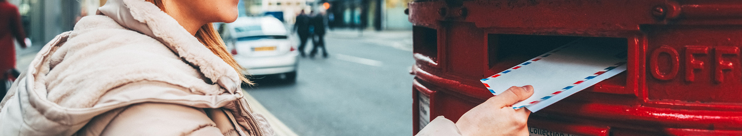Someone putting a letting into a post box. 