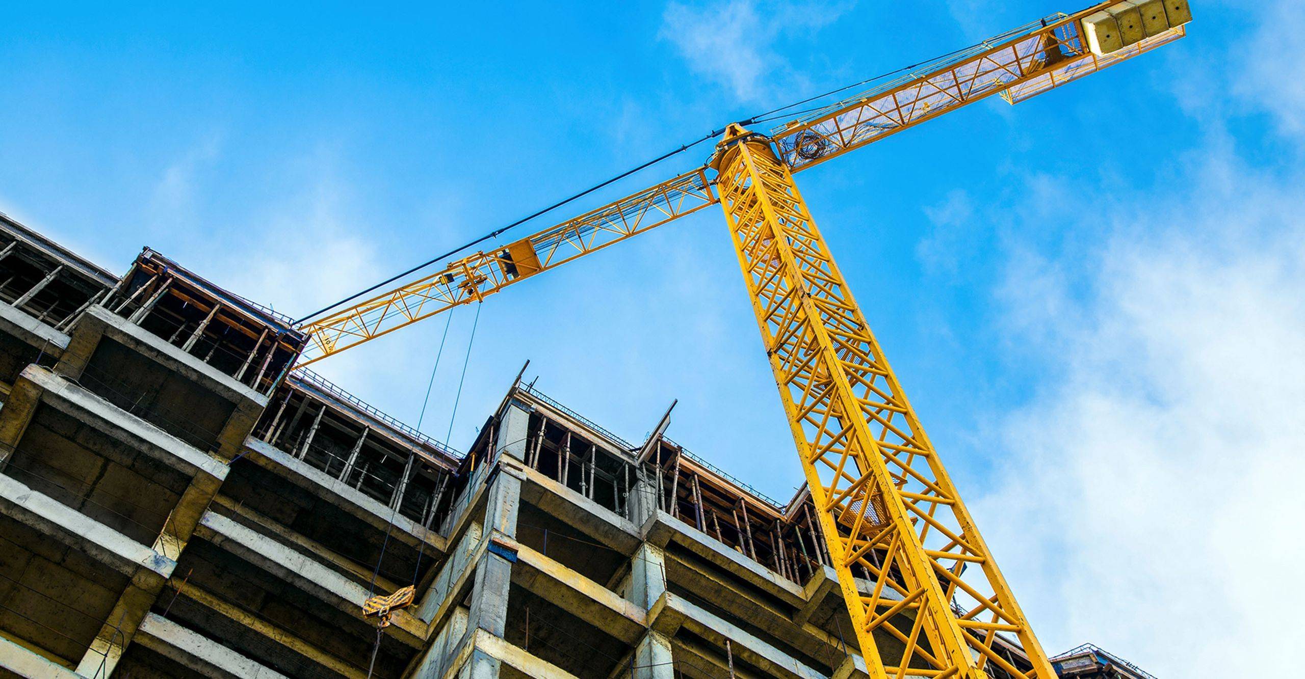 Looking up at a crane on a construction site